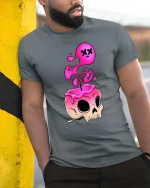 Melting Skull T-Shirt Pink Drip Gothic Graphic Tee - model wearing grey tee, leaning on column