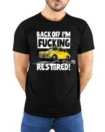 Back Off I’m Restoring Classic Car Mechanic Humor Tshirt - model wearing black tee with hands behind back