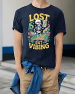 Lost But Vibing Funny Skeleton Retro Adventure Graphic T-Shirt - model wearing navy tee with hands in pockets