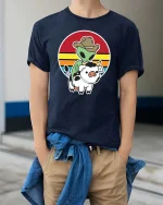 Alien Cowboy Riding Cow Funny Retro Sunset Graphic T-Shirt - model wearing navy tee with hands in pockets