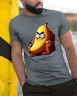 Funny Angry Banana Cartoon Humor Graphic Cool T-Shirt - model wearing grey tee, leaning on column