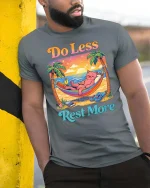 Do Less Rest More Cat Relaxing Beach Funny Graphic T-Shirt - model wearing grey tee, leaning on column