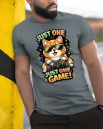Just One Game Funny Gamer Cat Cartoon Graphic T-Shirt - model wearing grey tee, leaning on column