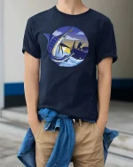 Marlin Fishing Sunset Graphic t-shirt Deep Sea Angler Tee - model wearing navy tee with hands in pockets