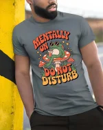 Mentally On Do Not Disturb Frog Funny Graphic t-shirt Tee - model wearing grey tee, leaning on column