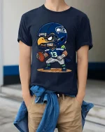 Cartoon Football Hawk T-Shirt Cute Sports Fan Game Day Style - model wearing navy tee with hands in pockets