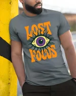 Lost Focus Eye T-Shirt Retro Psychedelic Graphic Style Tee - model wearing grey tee, leaning on column