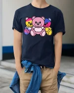 Colorful Neon Teddy Bear Trio Cute Graphic T-Shirt Design - model wearing navy tee with hands in pockets