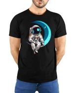 Astronaut Sitting On Moon Cute Space Graphic T-Shirt Design - model wearing black tee with hands behind back