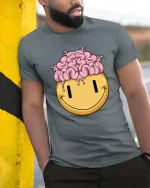 Funny Brain Melt Smiley Face Graphic T Shirt Humor Tee - model wearing grey tee, leaning on column