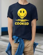 Funny Melted Smile Cooked Tshirt Drip Emoji Graphic Tee - model wearing navy tee with hands in pockets