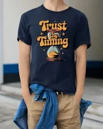 Trust The Timing Motivational Quote Graphic Tshirt Style - model wearing navy tee with hands in pockets