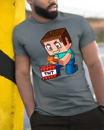 Block Game TNT Blast Cartoon Gamer Graphic Tshirt Fun - model wearing grey tee, leaning on column