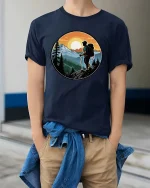 Mountain Hiking Adventure Sunset Nature Explorer Graphic Tshirt - model wearing navy tee with hands in pockets