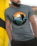 Mountain Hiking Adventure Sunset Nature Explorer Graphic Tshirt - model wearing grey tee, leaning on column
