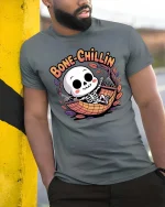 Bone Chillin Funny Skeleton Hammock Relax Cartoon Tshirt - model wearing grey tee, leaning on column