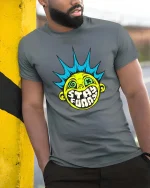 Stay Funny Punk Smile Face Retro Street Art Graphic Tshirt - model wearing grey tee, leaning on column