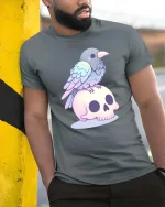 Cute Raven Skull Pastel Gothic Aesthetic Kawaii Tshirt - model wearing grey tee, leaning on column
