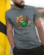 Funny Eagle Soccer Player Mexico Fan Cartoon Tshirt - model wearing grey tee, leaning on column