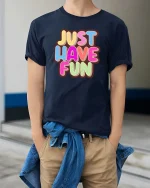 Just Have Fun Tshirt Colorful Positive Quote Graphic Tee - model wearing navy tee with hands in pockets