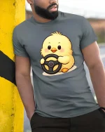 Cute Baby Chick Driving Wheel Cartoon Graphic Tshirt Fun - model wearing grey tee, leaning on column